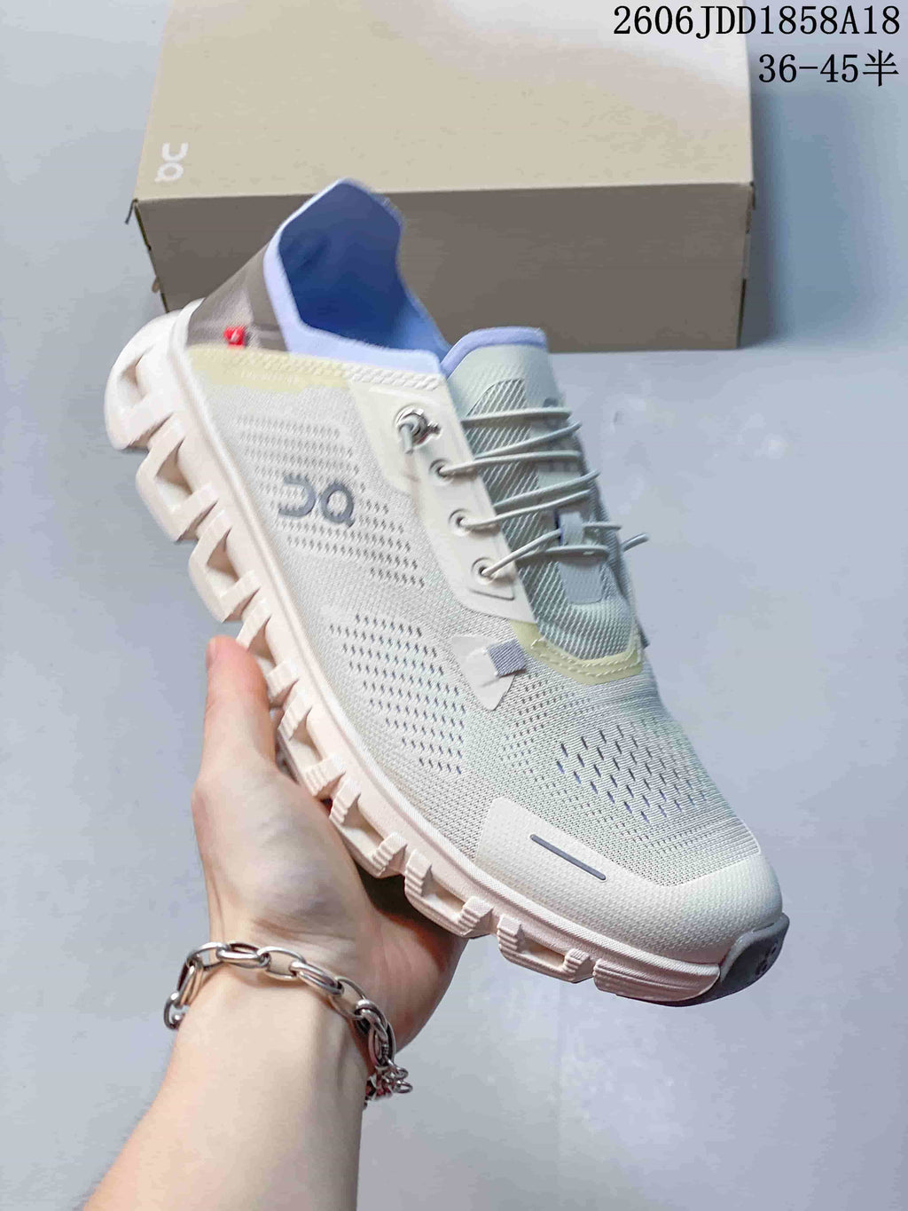 Angled view of the light-colored On Cloud 6 Coast sneaker