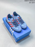 Light blue and red Adidas Handball Spezial sneakers displayed on a blue shoe box