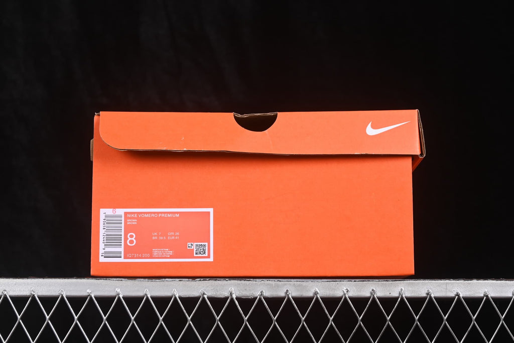 Orange Nike shoebox with a product label showing Nike Vomero Premium, style code IO7314-200, and photographed size information.