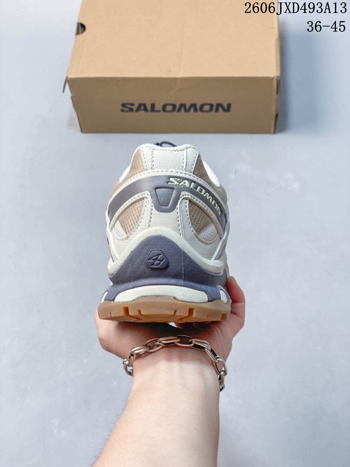 Rear view of a cream and gray Salomon XA Pro 3D sneaker.