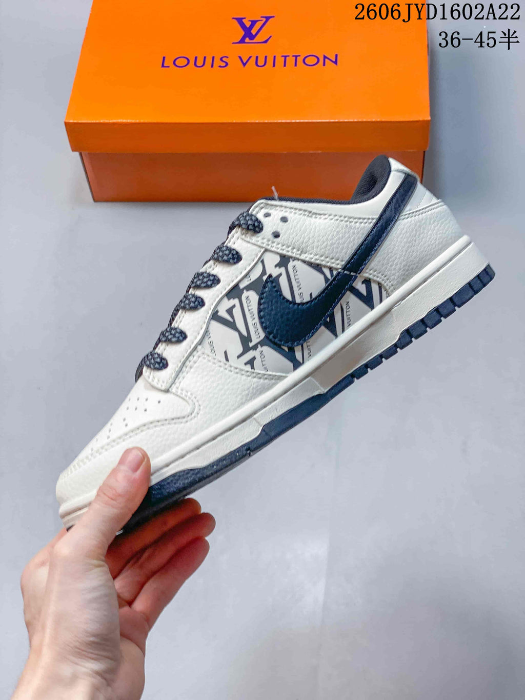 Side view of a white low-top sneaker with navy accents and patterned side panel
