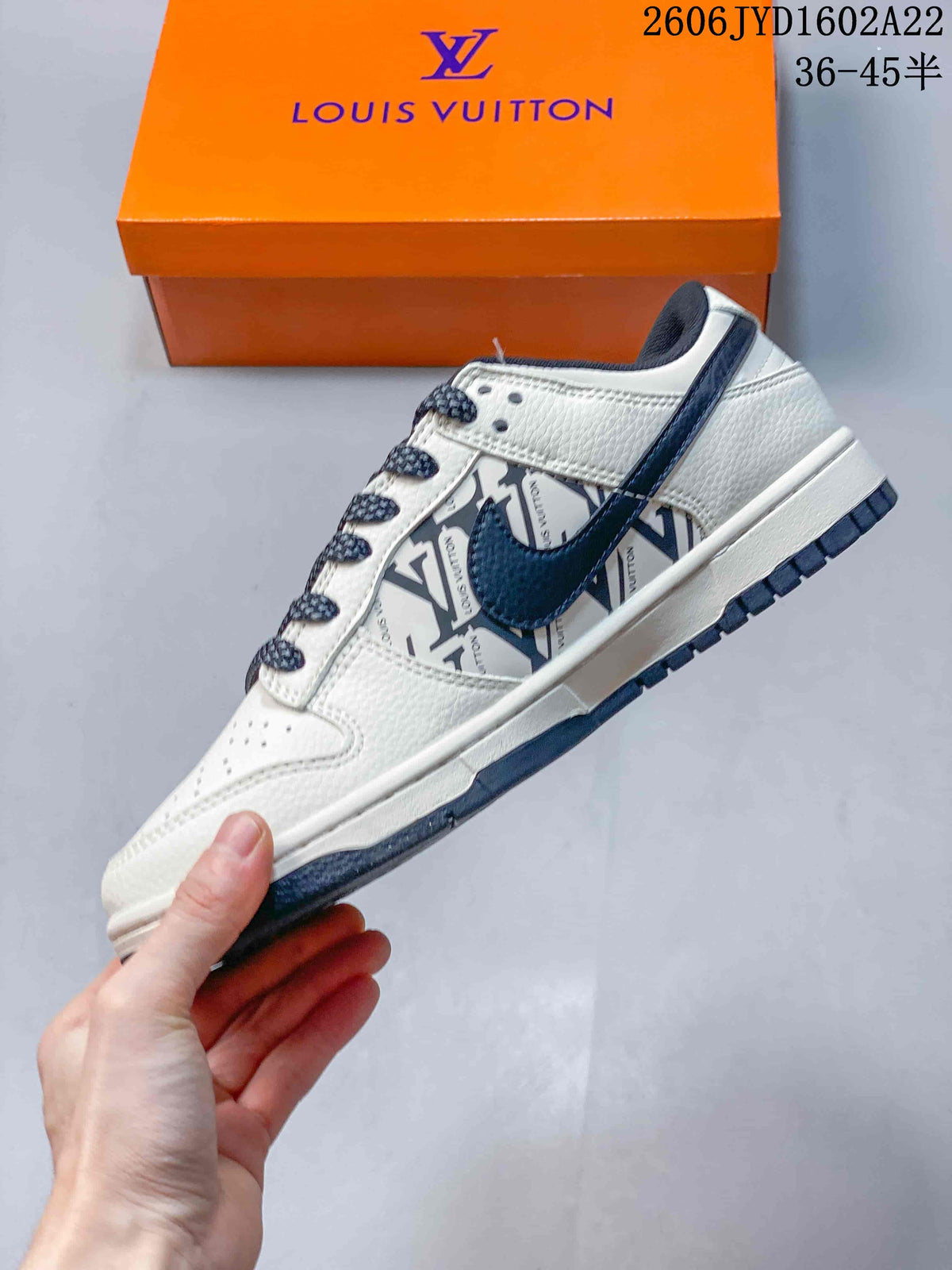 Side view of a white low-top sneaker with navy accents and patterned side panel