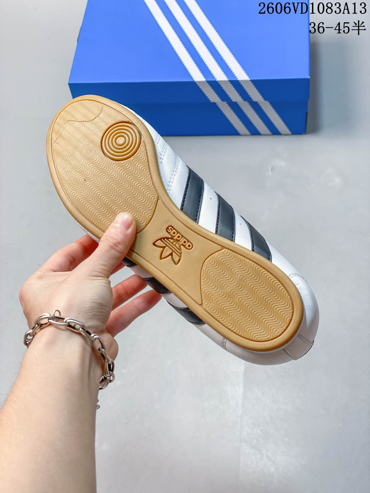 Close-up of the gum-colored textured outsole on a white Taekwondo sneaker