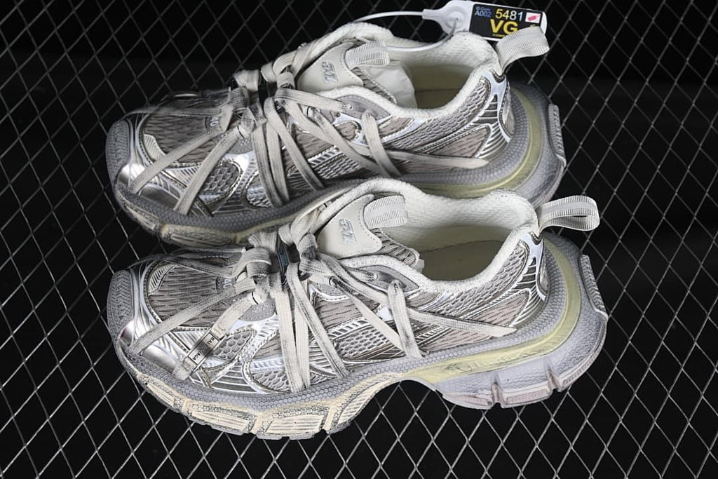 Pair of silver and grey sneakers displayed together