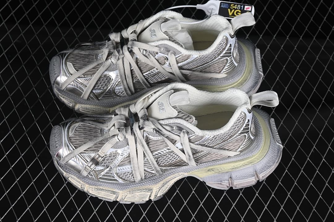 Pair of silver and grey sneakers displayed together