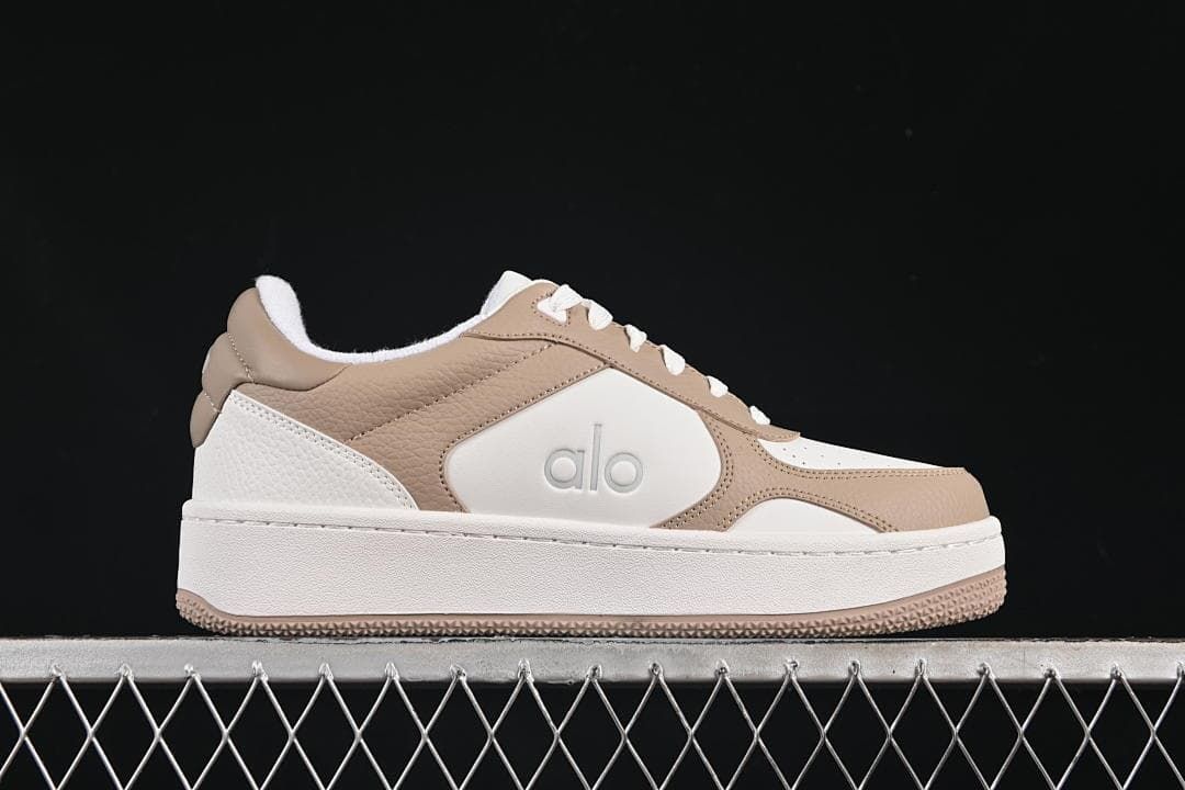 Side profile of a white and beige Alo Recovery Mode sneaker
