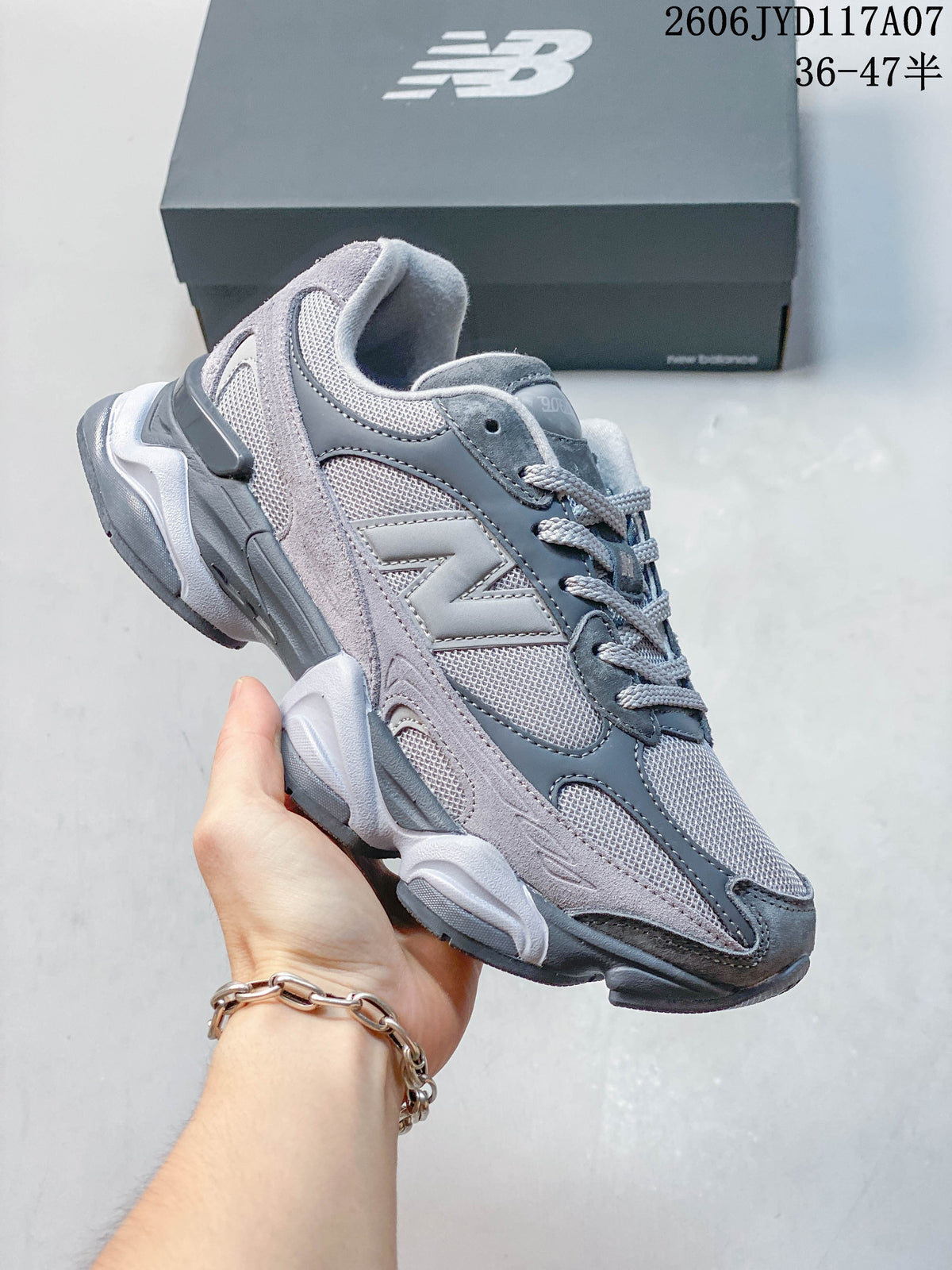 Angled side view of a grey New Balance 9060 sneaker showing its layered upper