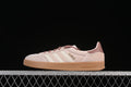 Side view of pink and cream adidas Gazelle Indoor sneakers with mauve accents and gum-colored sole