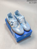 Pair of light blue Adidas Samba Jane Mary Jane sneakers with cream side stripes and brown outsoles