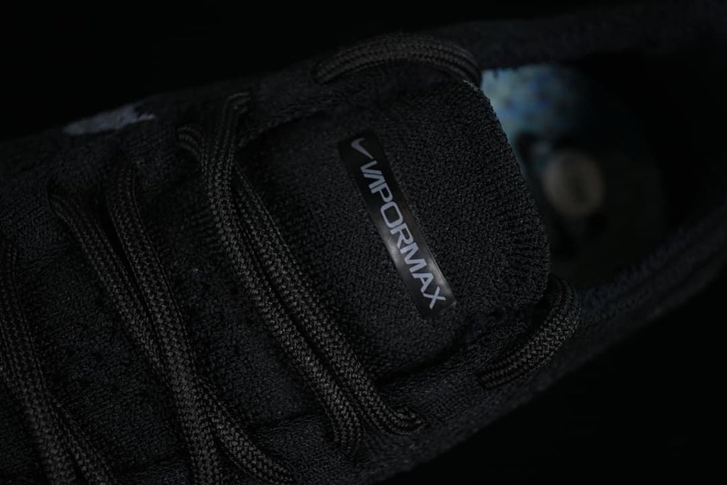 Close-up of the VaporMax tongue label and black laces