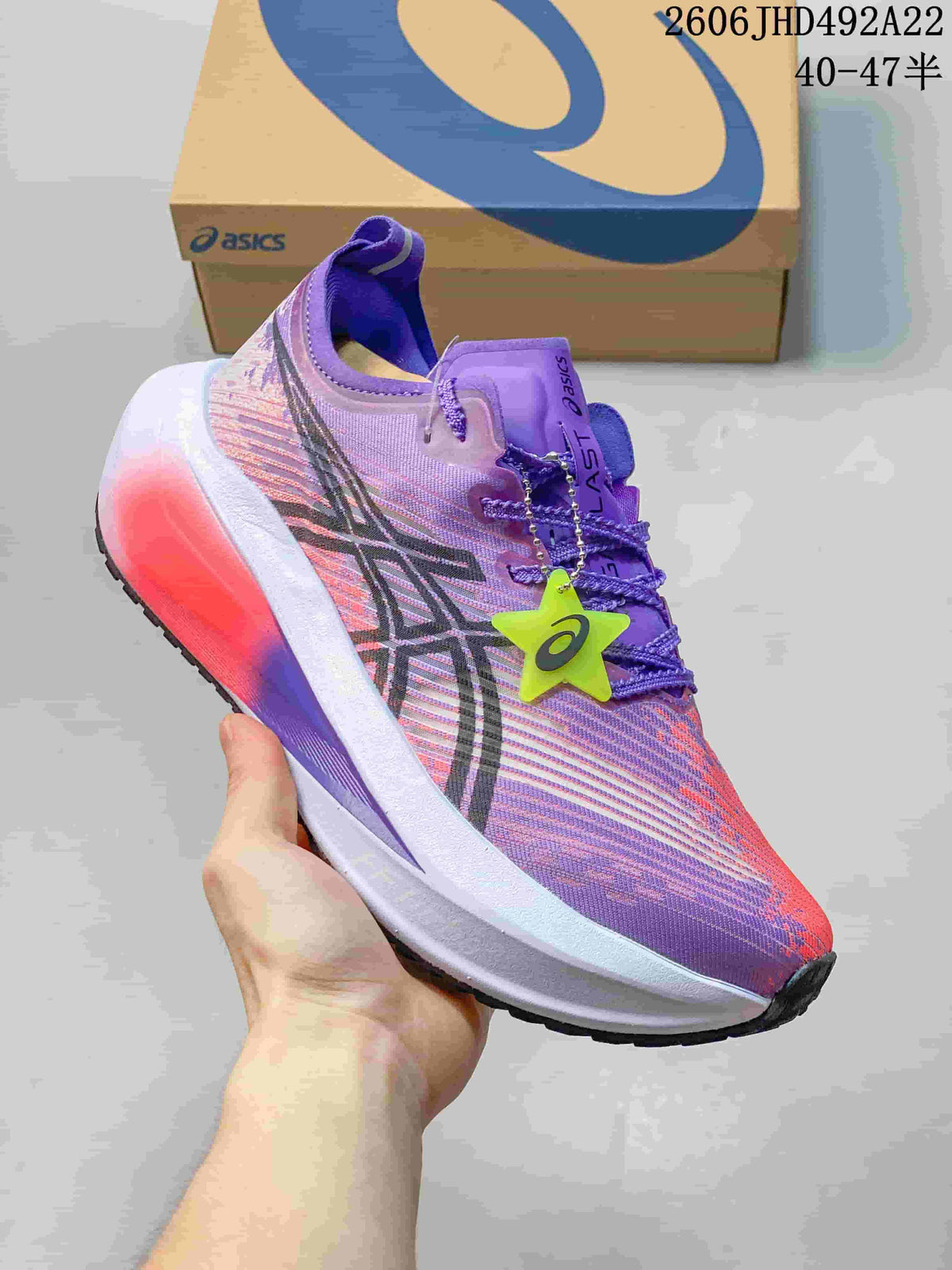 Side view of a purple and pink ASICS MEGABLAST shoe with a contrasting midsole