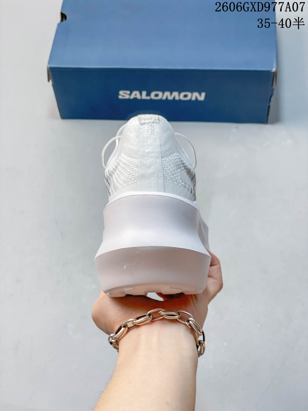 Rear view of a white sneaker with a thick sculpted platform sole.