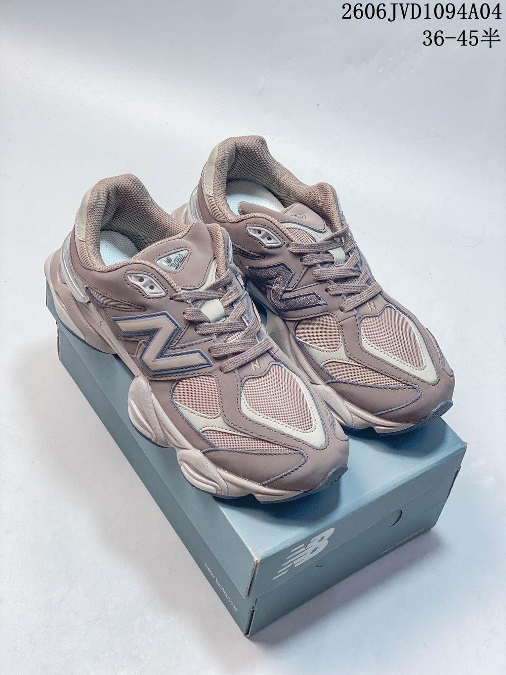 Pair of taupe and gray New Balance 410 low-top sneakers shown on a shoe box