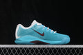 Side profile of aqua and white Nike Zoom Vapor 12 sneakers with burgundy Swoosh detail.