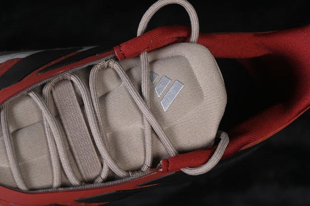 Top detail of tongue, laces and adidas logo