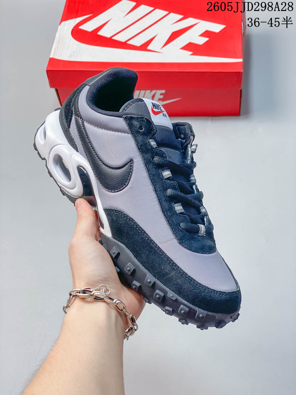 Angled side view of a gray and black low-top sneaker