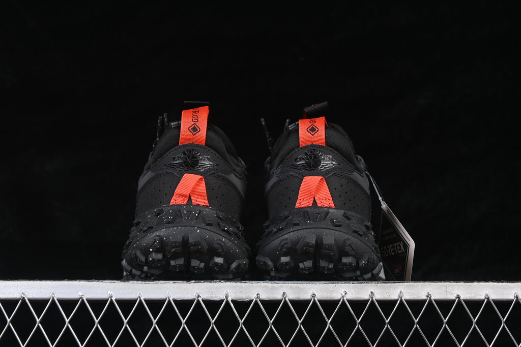 Rear view of the pair showing orange heel pulls and rugged outsole tread