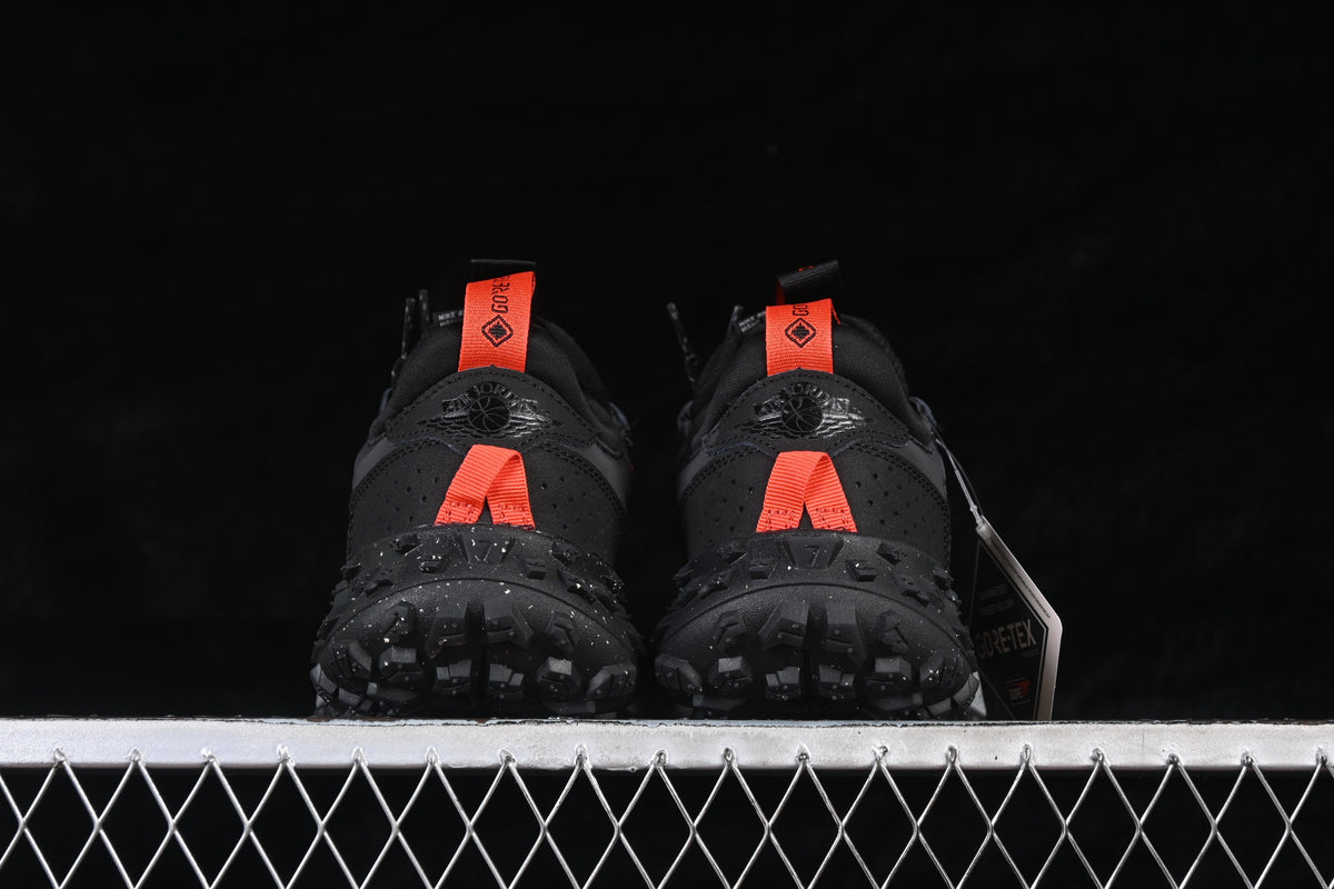 Rear view of the pair showing orange heel pulls and rugged outsole tread