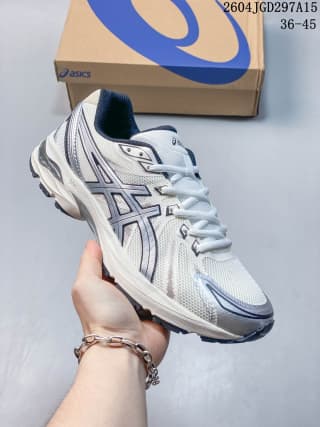 White and blue ASICS Gel-Flux CN sneaker with layered side panels and a sculpted sole.
