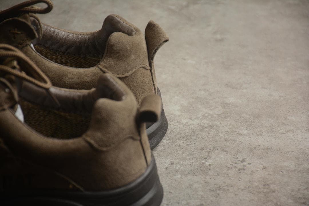 Rear close-up of the brown shoes showing padded collars and heel pull tabs.