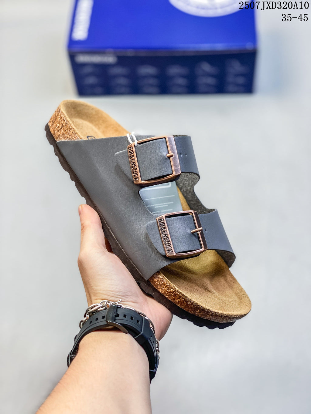 Close side view of a dark brown slide sandal with two adjustable buckles