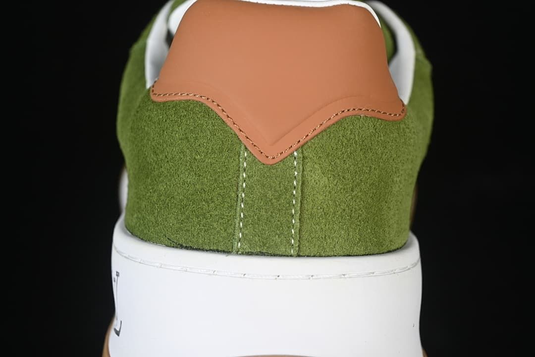 Rear view showing the tan heel accent and green upper