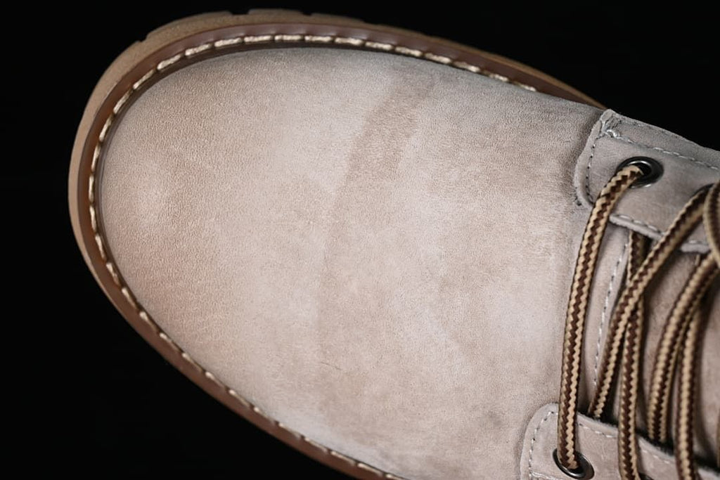 Close-up of the beige-grey boot toe and lace area
