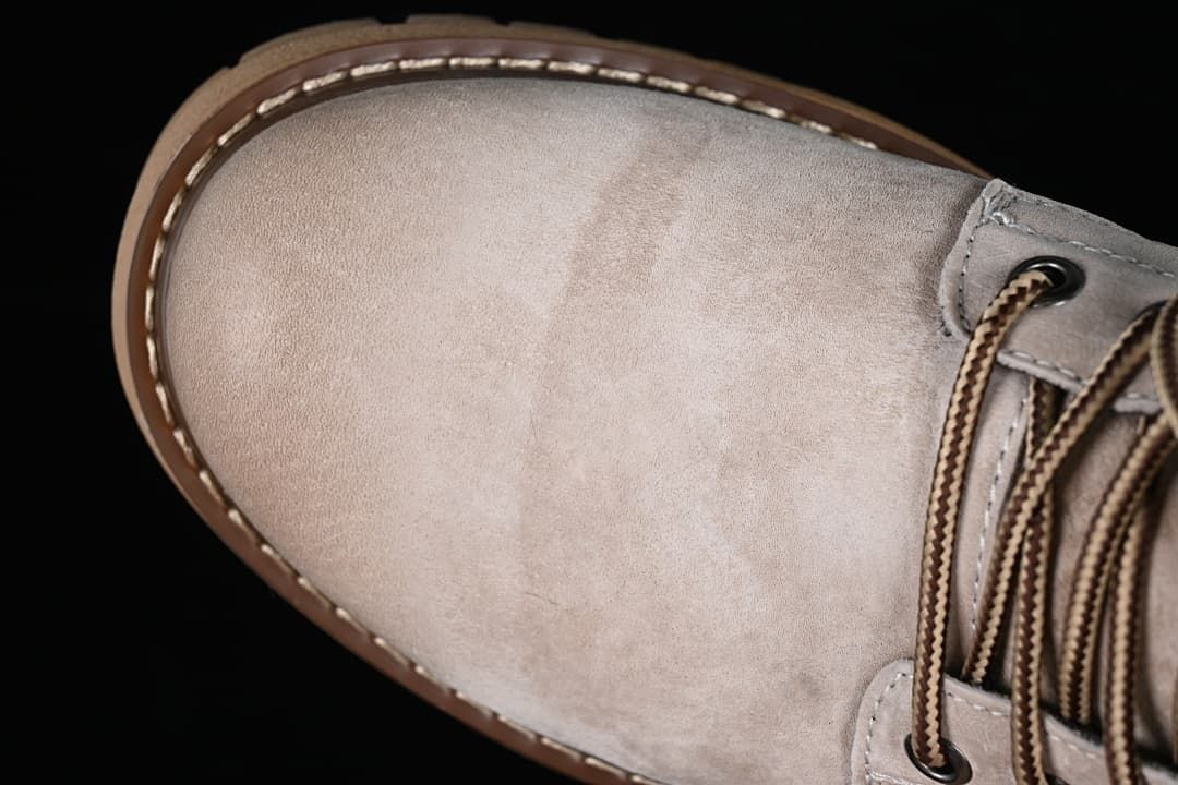 Close-up of the beige-grey boot toe and lace area