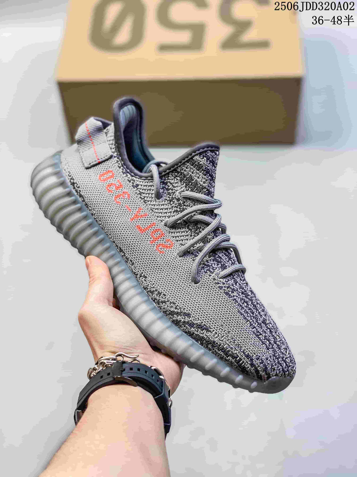 Gray knit-patterned sneaker with contrasting orange side lettering and a gray ribbed outsole