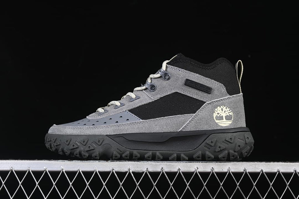 Side view of the grey and black Timberland mid-cut lace-up sneaker.