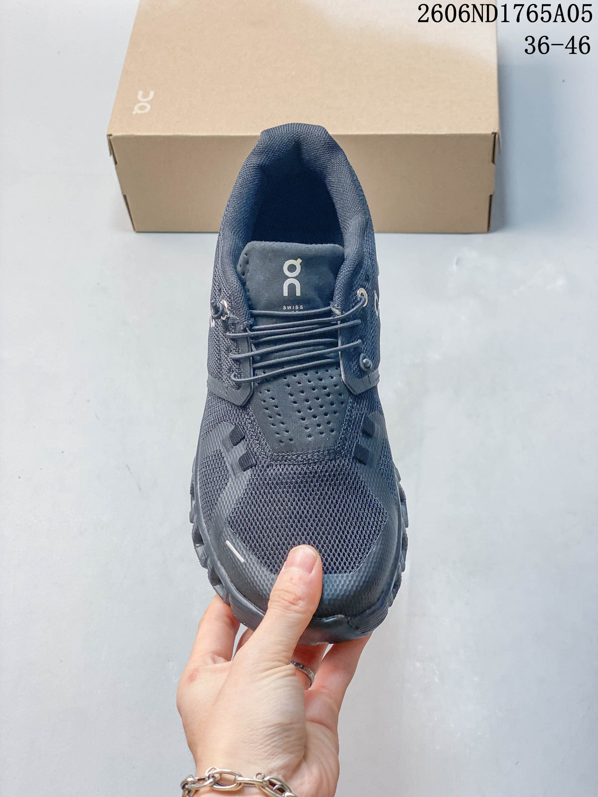 Top view of a dark gray sneaker showing its elastic lacing and mesh-look upper.