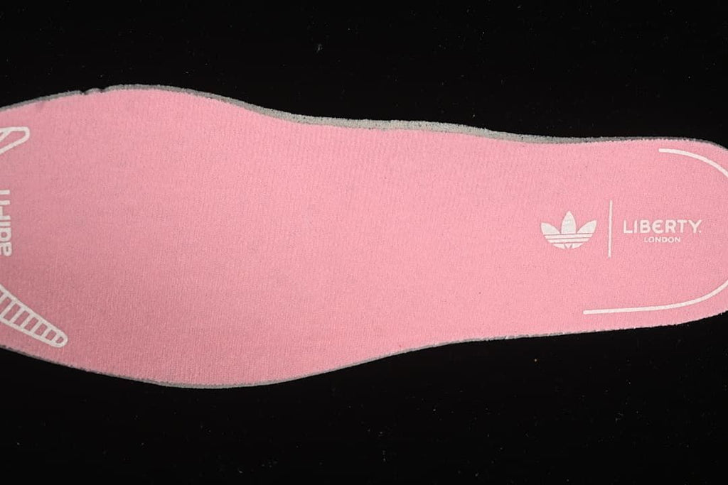 Pink insole with adidas Originals and Liberty London markings.