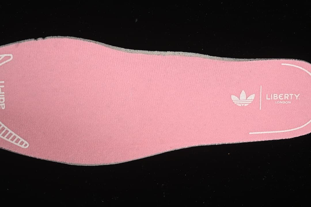 Pink insole with adidas Originals and Liberty London markings.