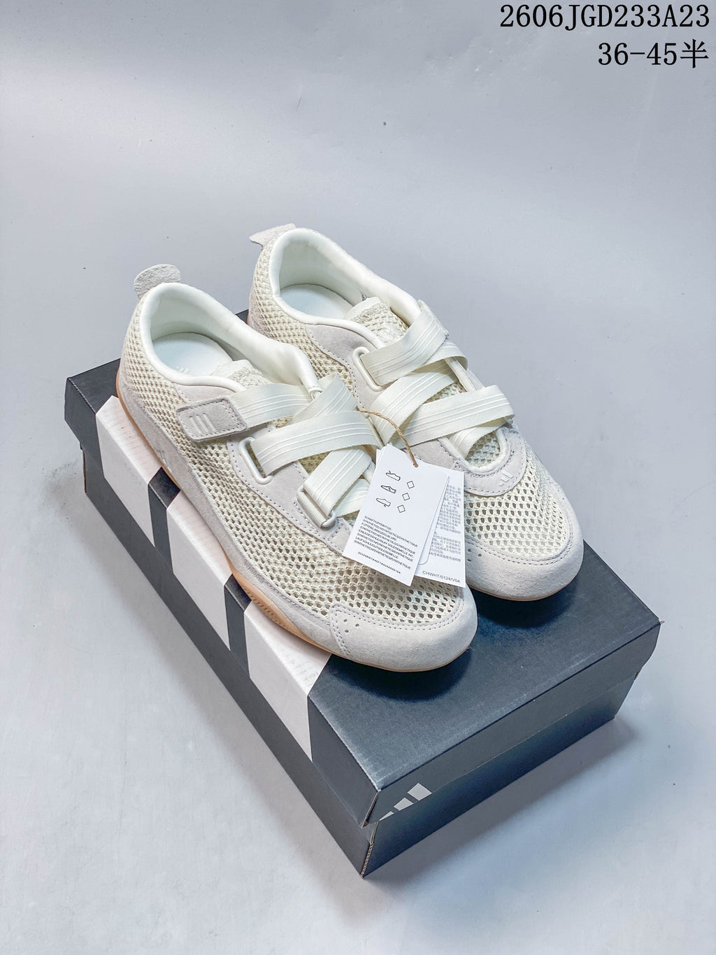 Pair of off-white adidas Urban Reverie low-top sneakers with strap-style closures and gum-colored soles