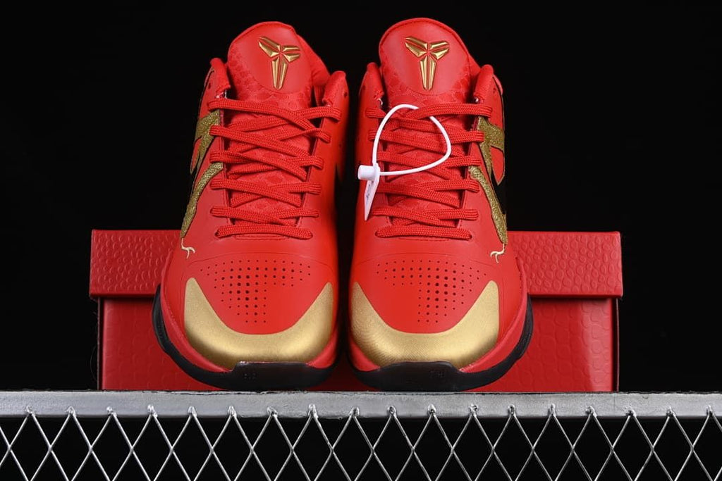 Front view of the pair showing red uppers and gold toe accents