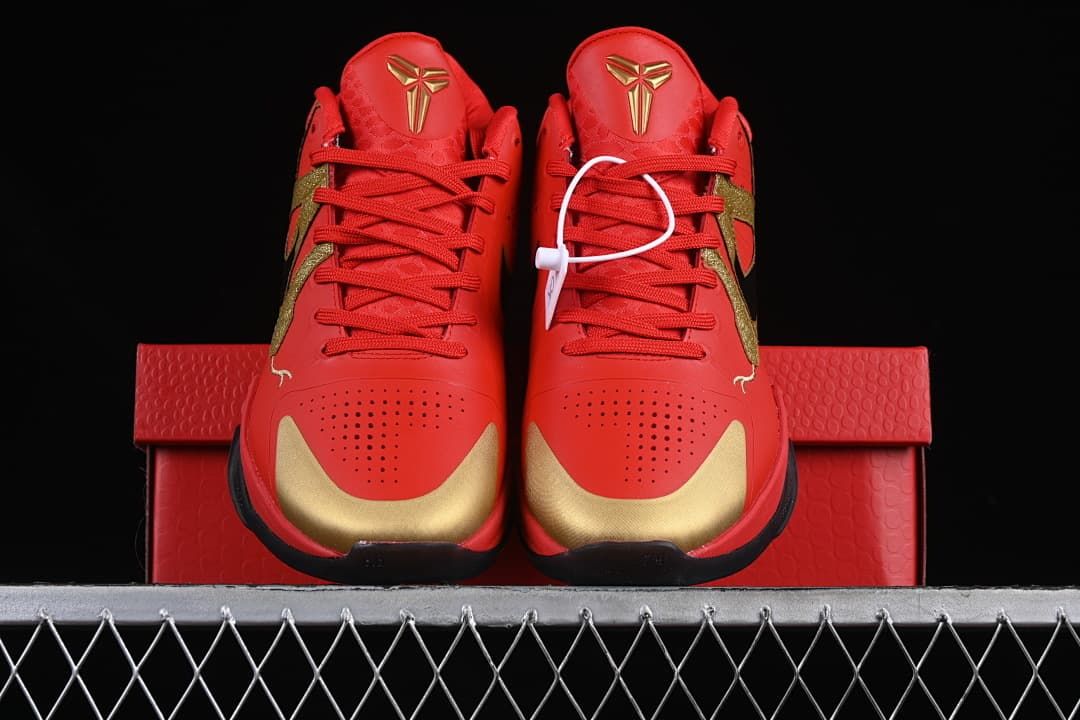 Front view of the pair showing red uppers and gold toe accents