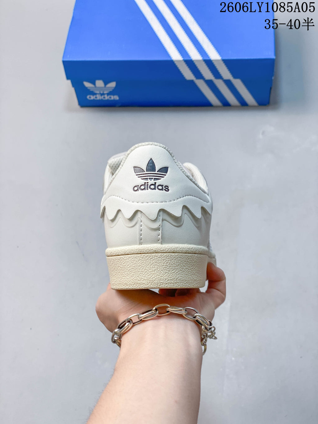 Rear view of an off-white Adidas Originals sneaker