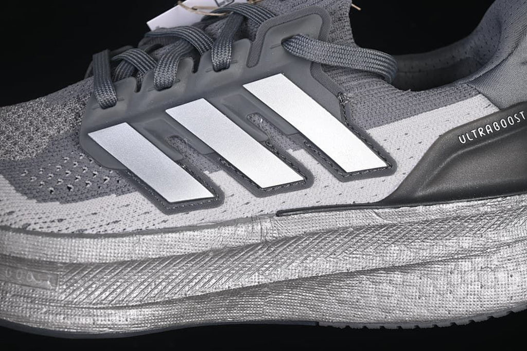 Close-up of the three-stripe side detail and midsole