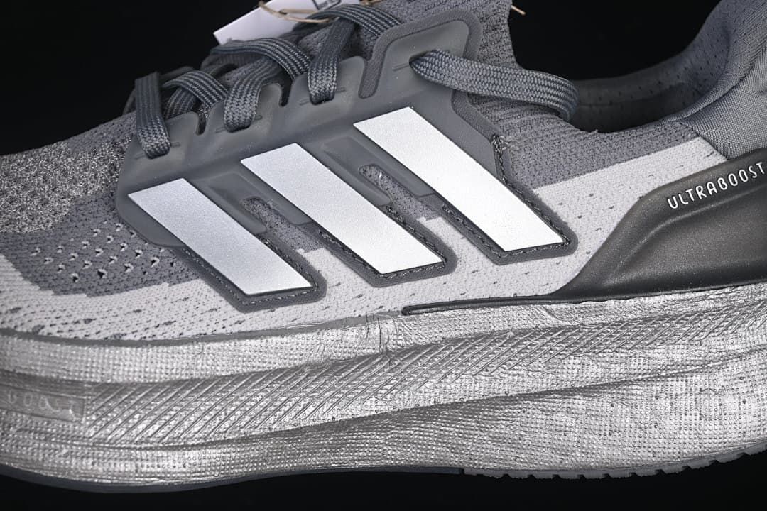 Close-up of the three-stripe side detail and midsole