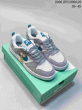 Pair of gray, white, and teal Nike SB Alleyoop low-top shoes on a teal shoebox