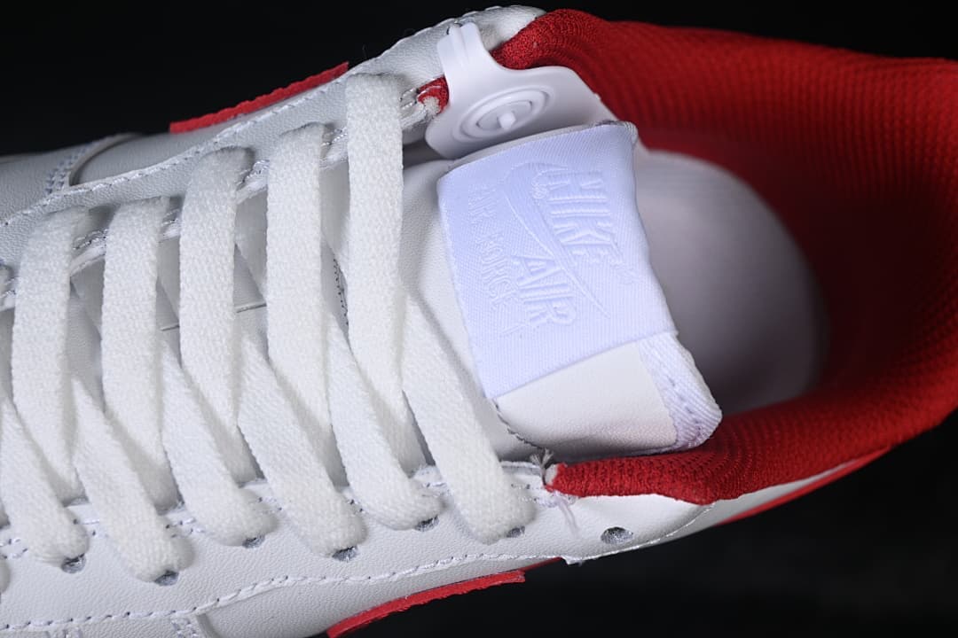 Close-up of the white laces, tongue, and red collar lining.