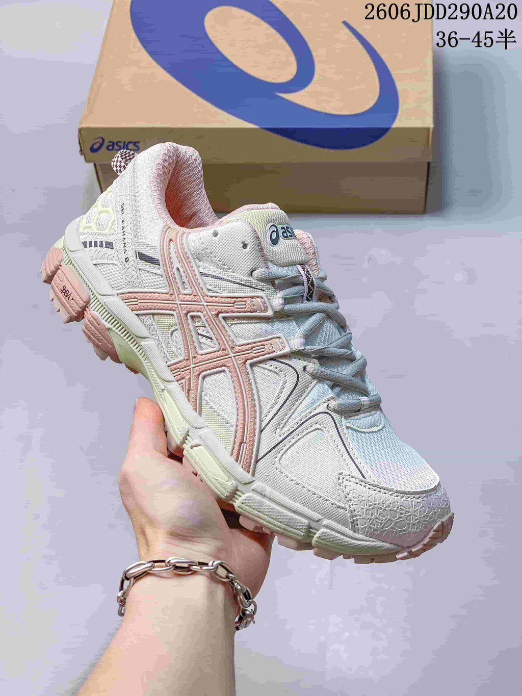 Close-up of a white ASICS Gel-Kahana 8 sneaker with pale pink accents.