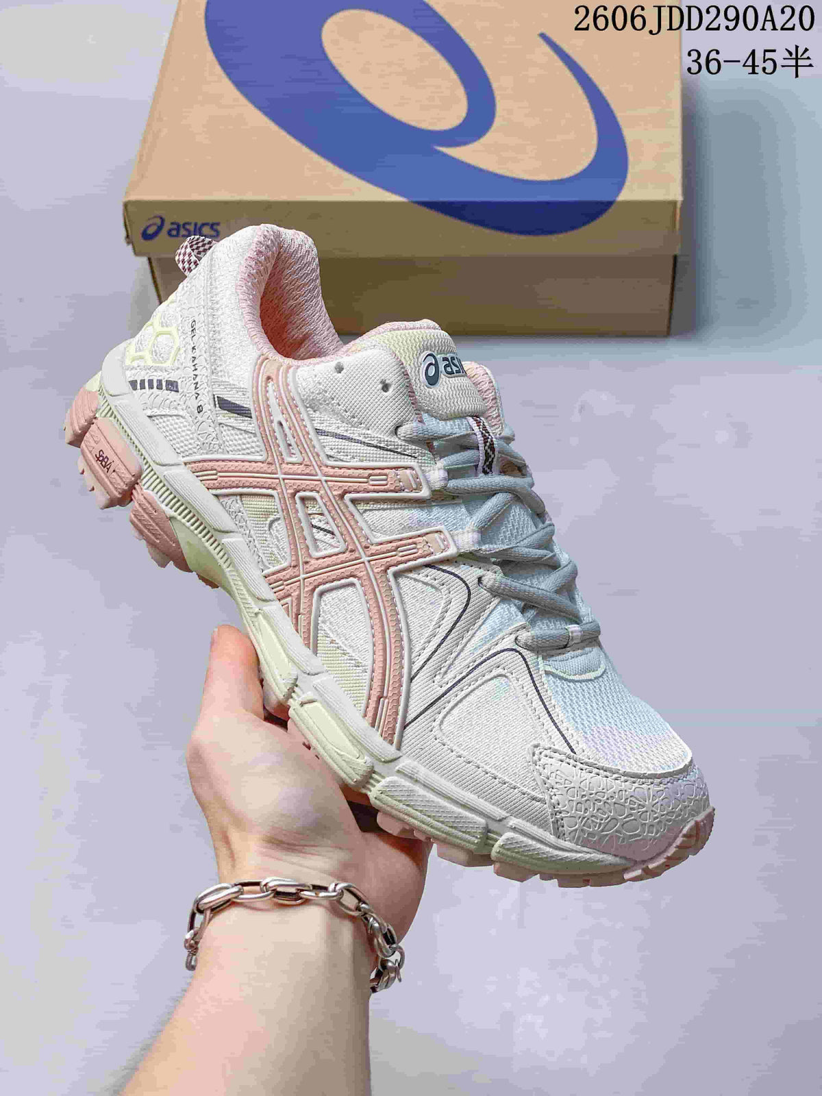 Close-up of a white ASICS Gel-Kahana 8 sneaker with pale pink accents.