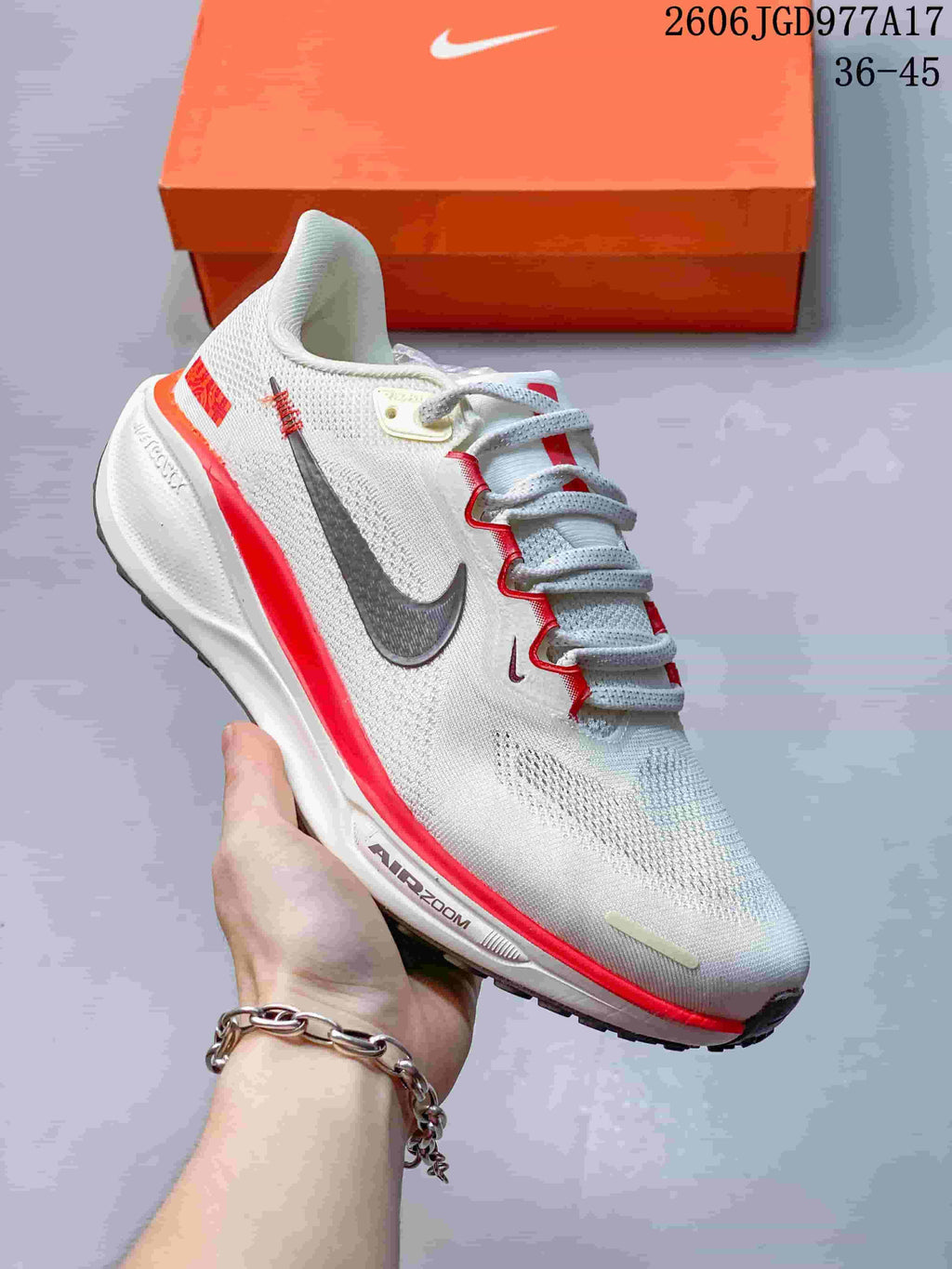 Side view of a light Pegasus 41 shoe with red trim and dark Swoosh