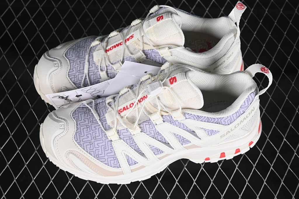 Pair of light Salomon XA Pro 3D shoes with lavender panels and red accents.
