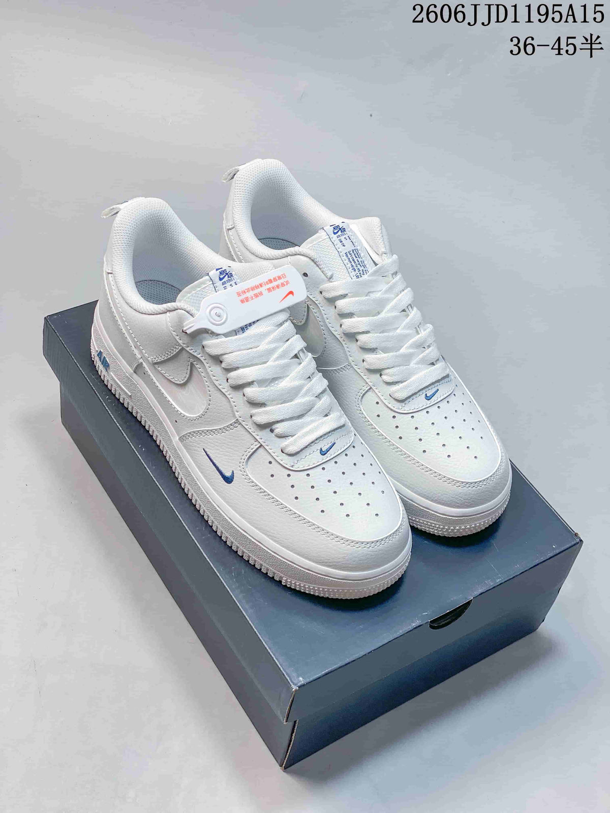 Pair of white low-top sneakers with small blue Swoosh accents and perforated toe panels.
