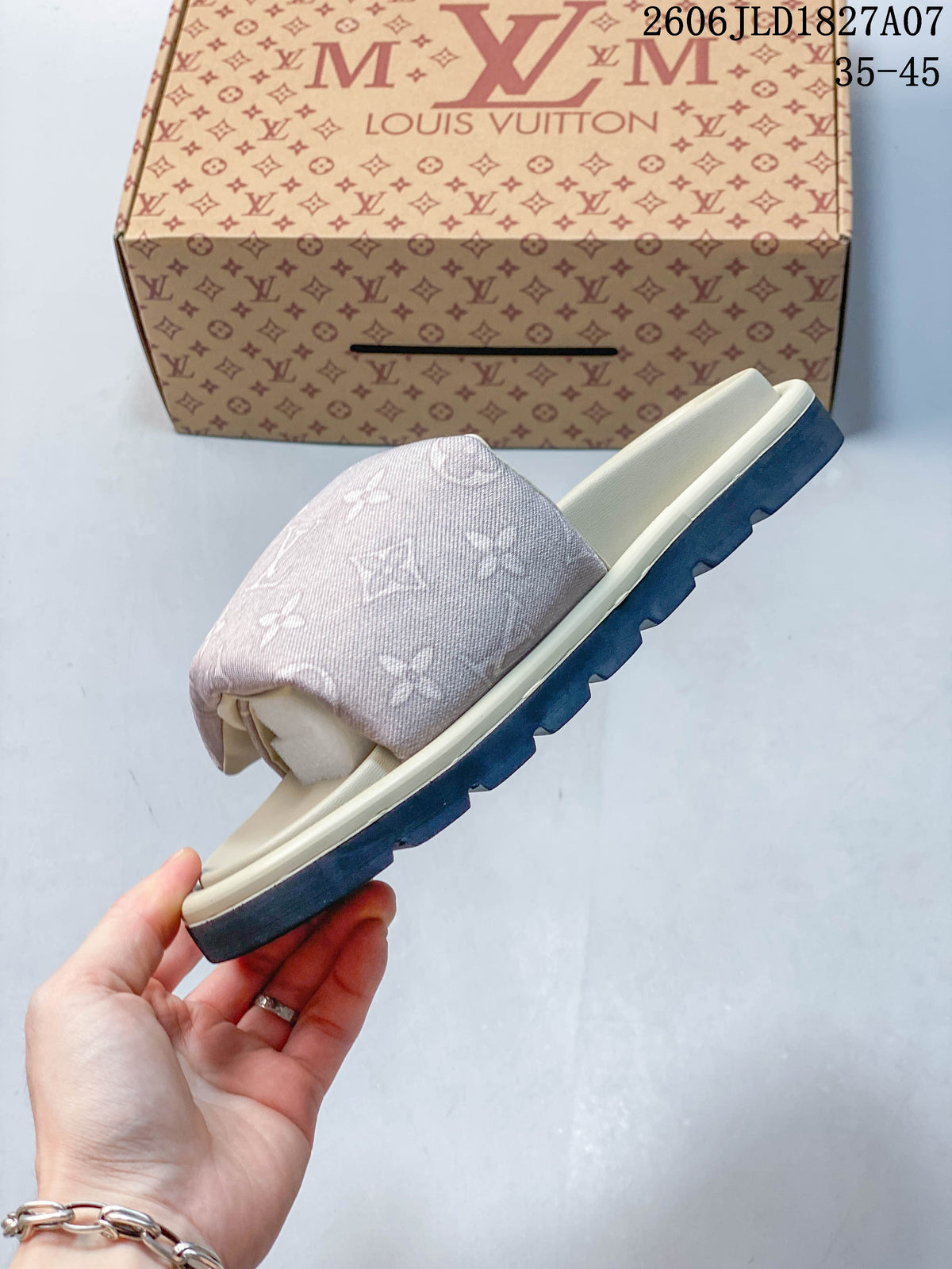 Side profile of a pale pink monogram slide sandal with a dark outsole