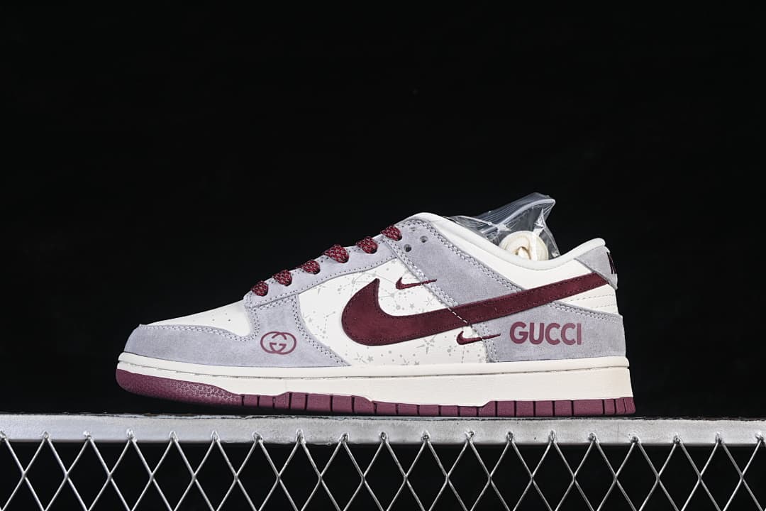 Side view of a gray, white, and burgundy Nike SB Dunk Low sneaker