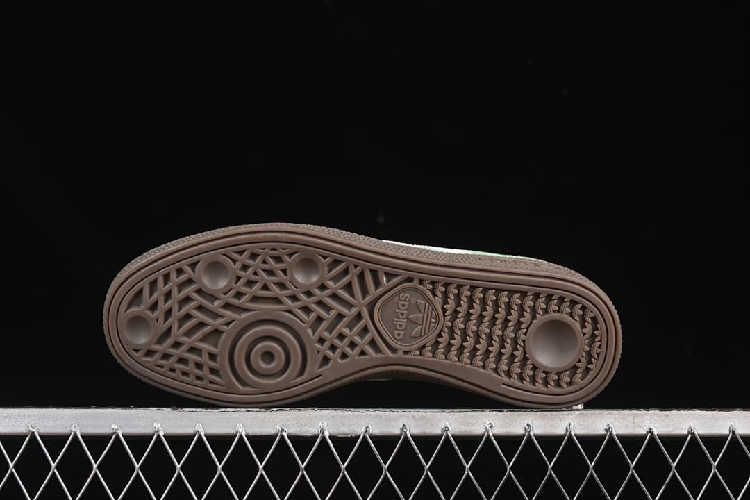 Underside of the sneaker showing the patterned brown outsole