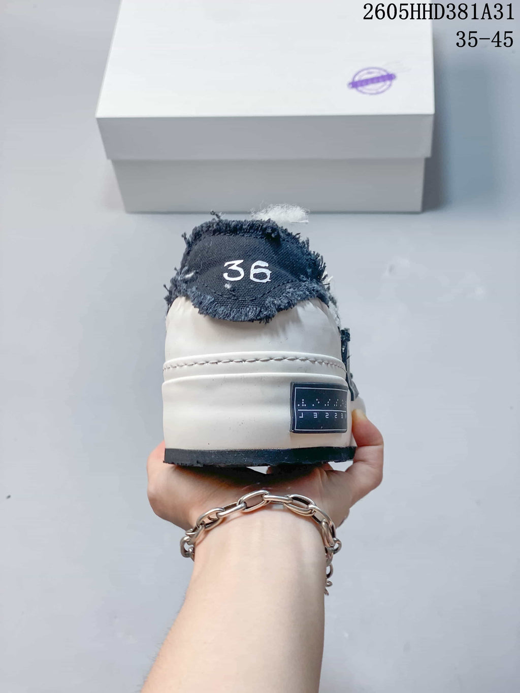 Rear view showing the heel, thick off-white sole, and sample size marking 36.